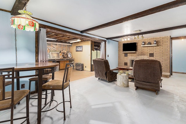 116 E Beech St, Fruitport, MI 49415 - dining area with a fireplace, beam ceiling, and concrete floors
