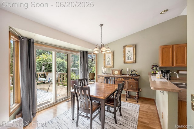33550 24 Mile Rd, Chesterfield, MI 48047 - dining area with lofted ceiling, light wood-type flooring, and a chandelier