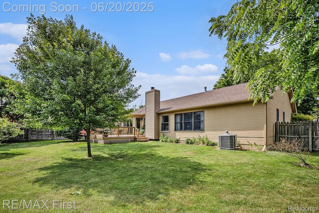 33550 24 Mile Rd, Chesterfield, MI 48047 - rear view of house featuring a fenced backyard, a deck, and a chimney