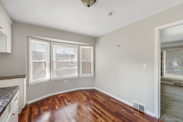 12892 Asbury Park, Detroit, MI 48227 - unfurnished dining area with dark wood-type flooring and baseboards