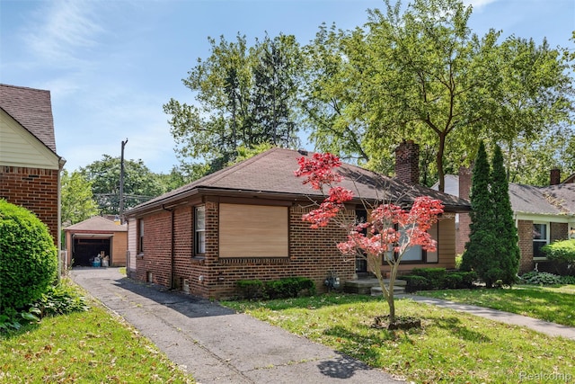 12892 Asbury Park, Detroit, MI 48227 - view of front of property with an outbuilding, brick siding, asphalt driveway, and a front yard