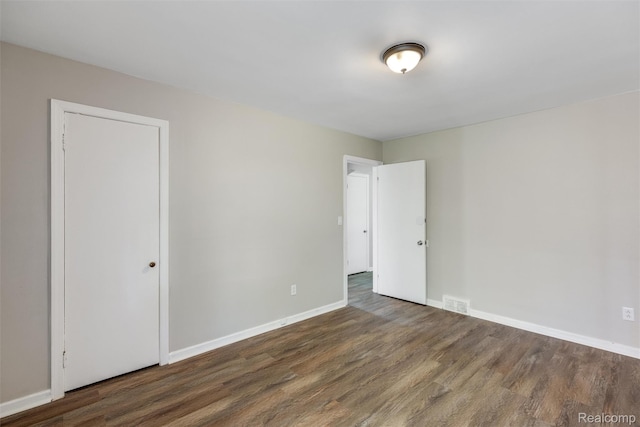 12892 Asbury Park, Detroit, MI 48227 - unfurnished bedroom with wood finished floors and baseboards
