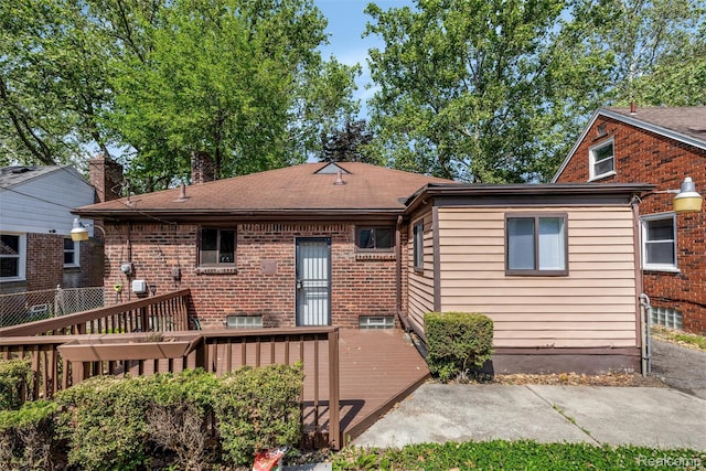 12892 Asbury Park, Detroit, MI 48227 - rear view of house featuring a deck, a chimney, and brick siding