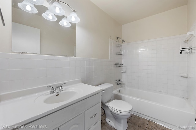 561 E Bennett Ave, Ferndale, MI 48220 - bathroom with tile walls, shower / washtub combination, vanity, tile patterned floors, and wainscoting
