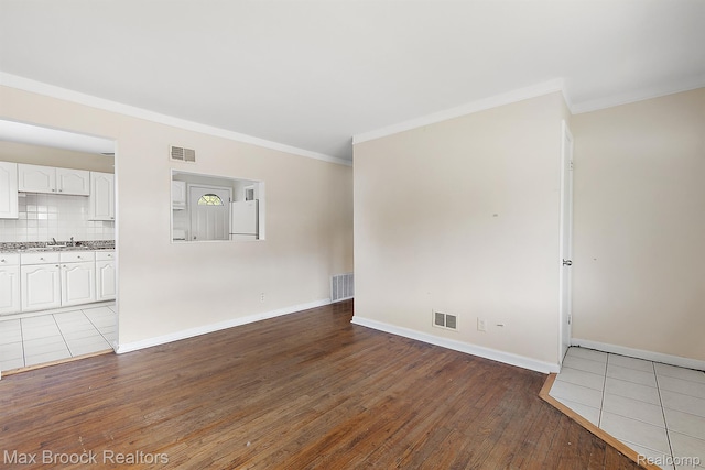 561 E Bennett Ave, Ferndale, MI 48220 - unfurnished living room with crown molding and hardwood / wood-style flooring