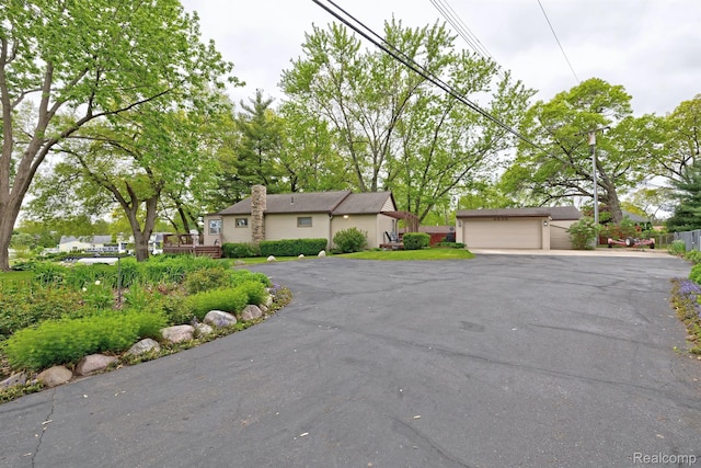 4030 Rollins Ave, Waterford, MI 48329 - view of front of house with a chimney and a wooden deck