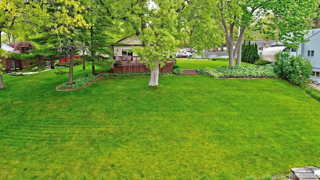 4030 Rollins Ave, Waterford, MI 48329 - view of grassy yard featuring a deck