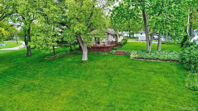4030 Rollins Ave, Waterford, MI 48329 - view of green lawn with a wooden deck