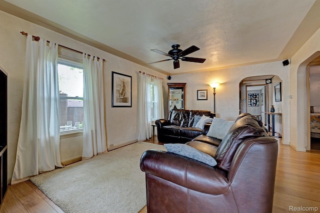 4030 Rollins Ave, Waterford, MI 48329 - living room featuring arched walkways, ceiling fan, and light wood-style flooring