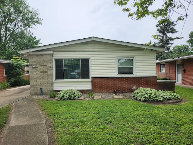 7965 Elm St, Taylor, MI 48180 - view of property exterior featuring a yard and brick siding