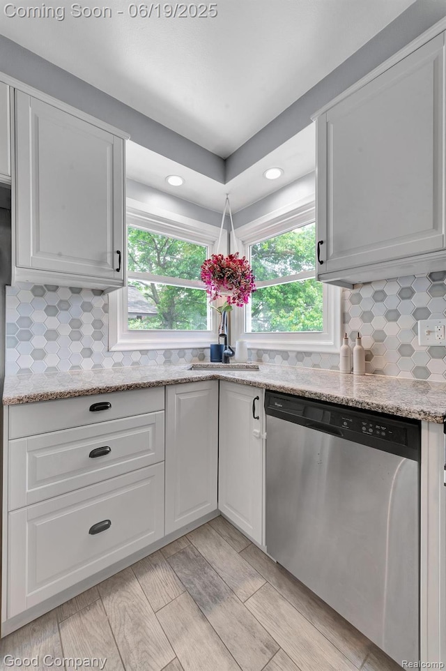 3979 Royal Ave, Berkley, MI 48072 - kitchen with stainless steel dishwasher, recessed lighting, white cabinetry, and plenty of natural light