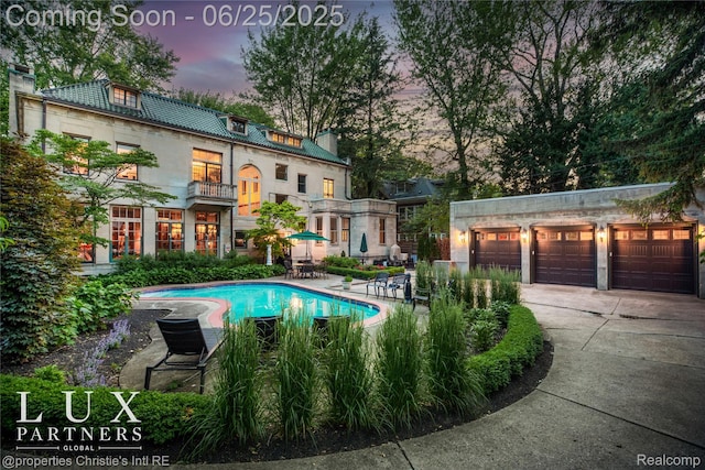 2150 Iroquois St, Detroit, MI 48201 - pool at dusk featuring an outdoor pool