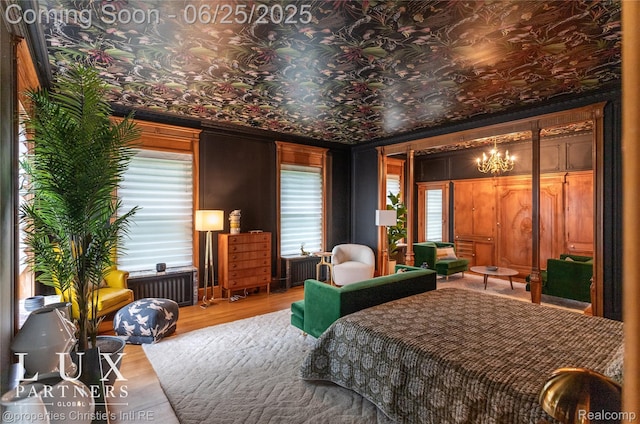 2150 Iroquois St, Detroit, MI 48201 - bedroom with wood finished floors, a chandelier, and radiator