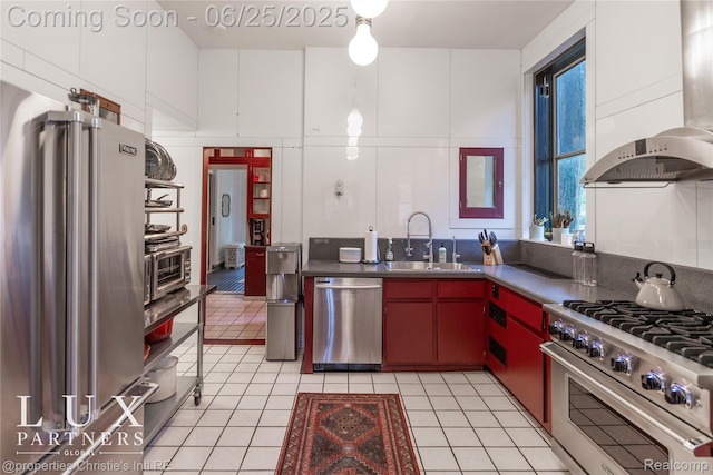 2150 Iroquois St, Detroit, MI 48201 - kitchen with high end appliances, wall chimney exhaust hood, light tile patterned flooring, and dark countertops