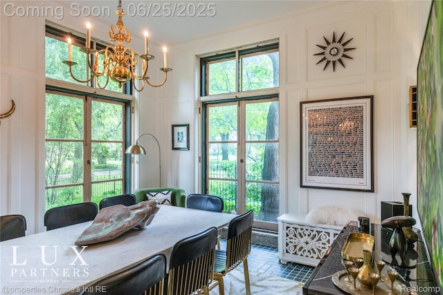 2150 Iroquois St, Detroit, MI 48201 - dining space featuring a decorative wall, a chandelier, and a towering ceiling