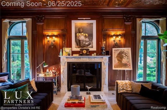2150 Iroquois St, Detroit, MI 48201 - living room featuring healthy amount of natural light, wooden walls, crown molding, and a high end fireplace