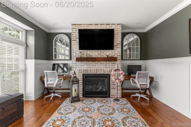 23736 Point O Woods Ct, South Lyon, MI 48178 - living room featuring a decorative wall, crown molding, hardwood / wood-style flooring, a fireplace, and a wainscoted wall