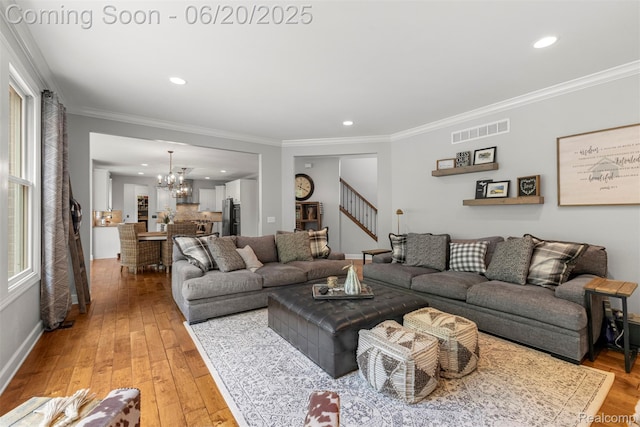 23736 Point O Woods Ct, South Lyon, MI 48178 - living room with a chandelier, stairs, light wood finished floors, crown molding, and recessed lighting