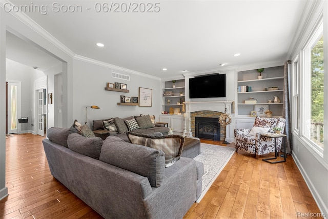 23736 Point O Woods Ct, South Lyon, MI 48178 - living room with a fireplace, light wood-style floors, recessed lighting, and ornamental molding