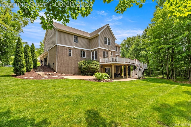23736 Point O Woods Ct, South Lyon, MI 48178 - rear view of house featuring a deck, brick siding, a patio area, and a yard