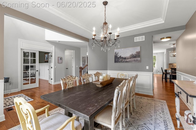 23736 Point O Woods Ct, South Lyon, MI 48178 - dining room with a raised ceiling, a chandelier, wood finished floors, crown molding, and a wainscoted wall