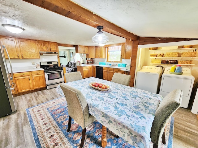 350 S Catalpa Ave, White Cloud, MI 49349 - dining space with washing machine and clothes dryer, light wood finished floors, and beamed ceiling