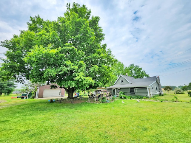 350 S Catalpa Ave, White Cloud, MI 49349 - view of grassy yard with an outdoor structure and a garage