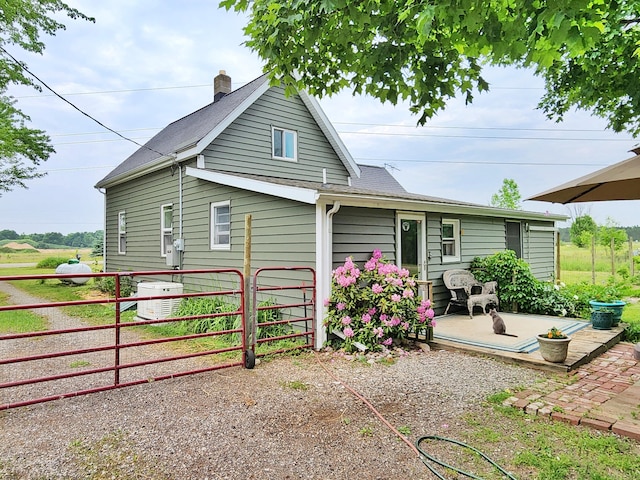 350 S Catalpa Ave, White Cloud, MI 49349 - rear view of house with a chimney and roof with shingles