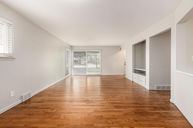 32530 Halmich Dr, Warren, MI 48092 - empty room with built in shelves and wood finished floors