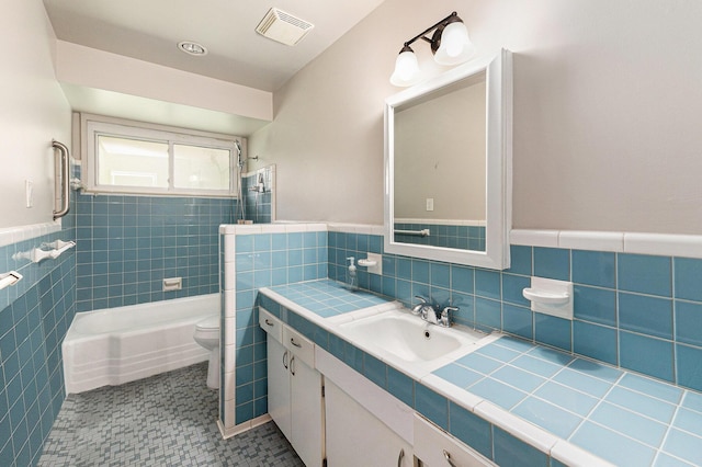 32530 Halmich Dr, Warren, MI 48092 - full bathroom with tile walls, vanity, a wainscoted wall, and shower / washtub combination