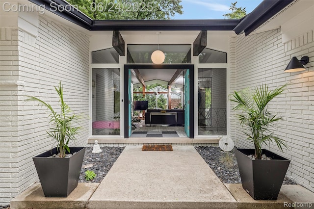 6895 Cedarbrook Dr, Bloomfield Hills, MI 48301 - view of exterior entry with a patio and brick siding