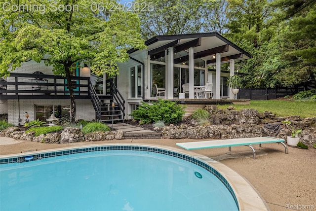 6895 Cedarbrook Dr, Bloomfield Hills, MI 48301 - outdoor pool with stairway, a diving board, and a wooden deck