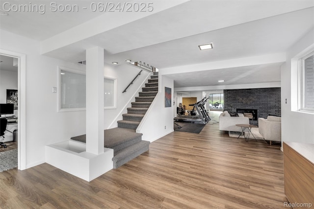 6895 Cedarbrook Dr, Bloomfield Hills, MI 48301 - stairway with wood finished floors and a brick fireplace