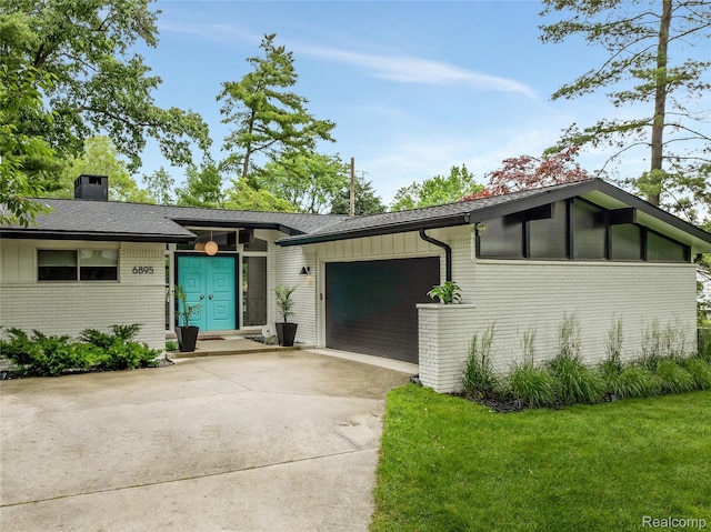 6895 Cedarbrook Dr, Bloomfield Hills, MI 48301 - view of front facade featuring brick siding, an attached garage, driveway, a chimney, and a front yard