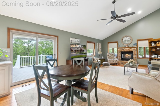 459 N Elms Rd, Flushing, MI 48433 - dining area with healthy amount of natural light, a brick fireplace, ceiling fan, and high vaulted ceiling
