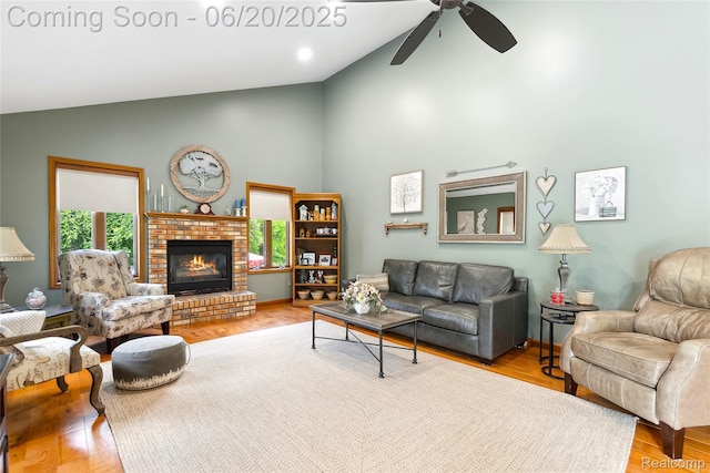 459 N Elms Rd, Flushing, MI 48433 - living area featuring high vaulted ceiling, ceiling fan, a fireplace, and wood finished floors