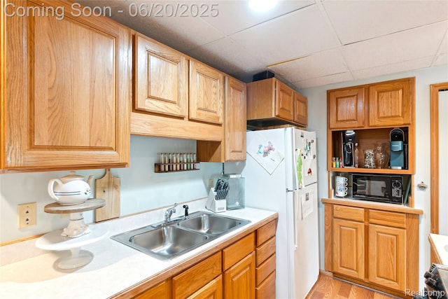 459 N Elms Rd, Flushing, MI 48433 - kitchen with black microwave, light countertops, a paneled ceiling, light wood-style floors, and freestanding refrigerator
