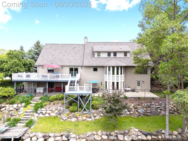 459 N Elms Rd, Flushing, MI 48433 - rear view of house with a patio area, a wooden deck, stairway, a chimney, and roof with shingles