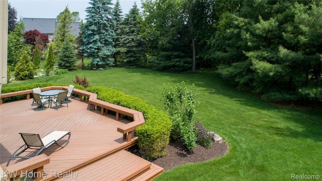 2836 Otter Ct, Wixom, MI 48393 - view of grassy yard featuring a wooden deck and outdoor dining space