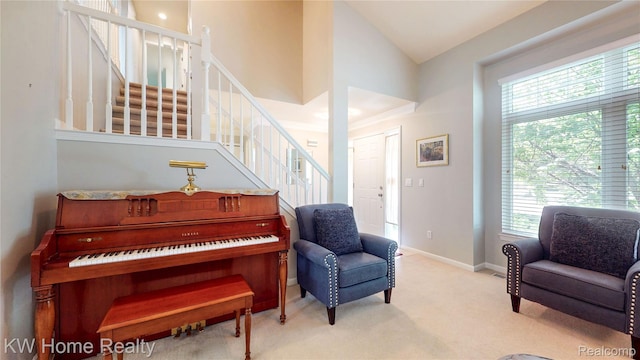 2836 Otter Ct, Wixom, MI 48393 - sitting room featuring plenty of natural light, lofted ceiling, stairway, and carpet