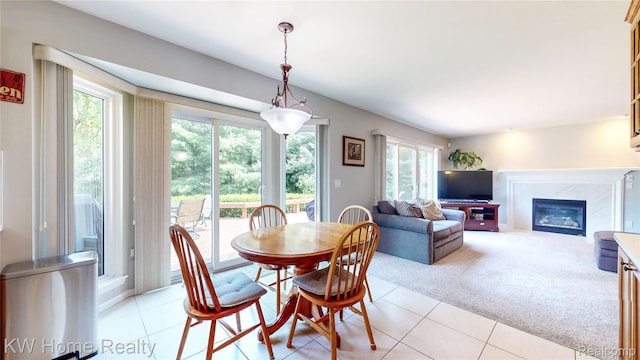 2836 Otter Ct, Wixom, MI 48393 - dining room featuring light tile patterned flooring, light colored carpet, and a high end fireplace