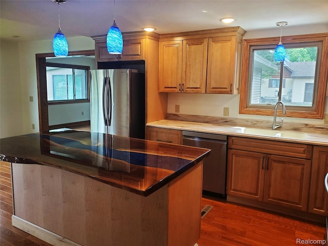 115 Choctaw Trl, Prudenville, MI 48651 - kitchen featuring appliances with stainless steel finishes, wood finished floors, decorative light fixtures, and recessed lighting