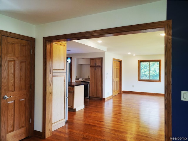 115 Choctaw Trl, Prudenville, MI 48651 - unfurnished living room featuring dark wood-type flooring and recessed lighting