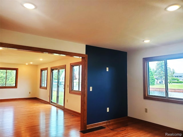 115 Choctaw Trl, Prudenville, MI 48651 - spare room featuring wood finished floors, healthy amount of natural light, and recessed lighting