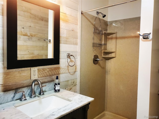 115 Choctaw Trl, Prudenville, MI 48651 - bathroom featuring a stall shower, vanity, and tasteful backsplash