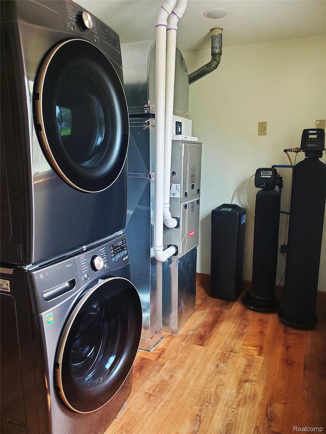 115 Choctaw Trl, Prudenville, MI 48651 - laundry area with stacked washer / drying machine and wood finished floors