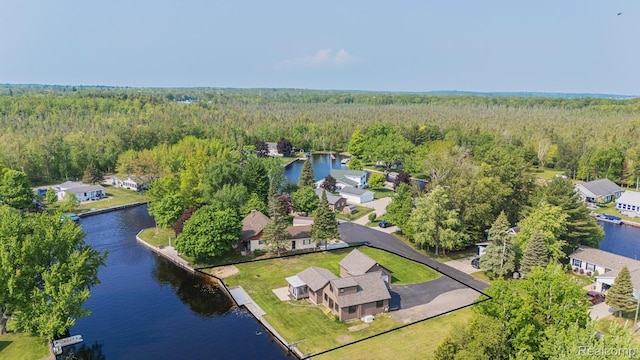 115 Choctaw Trl, Prudenville, MI 48651 - aerial perspective of suburban area featuring a heavily wooded area and a large body of water