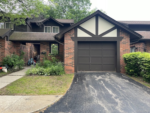 29332 Wellington Rd W, Southfield, MI 48034 - view of front of house with an attached garage, driveway, brick siding, and a shingled roof
