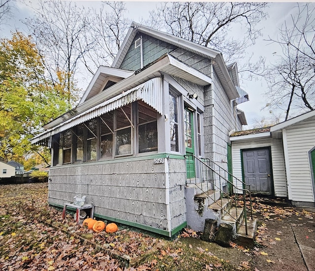 1643 Henry St, Muskegon, MI 49441 - view of home's exterior with a sunroom