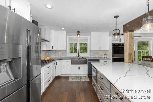 1495 Yeckley Rd, Hastings, MI 49058 - kitchen featuring appliances with stainless steel finishes, dark wood-style flooring, plenty of natural light, light stone counters, and recessed lighting